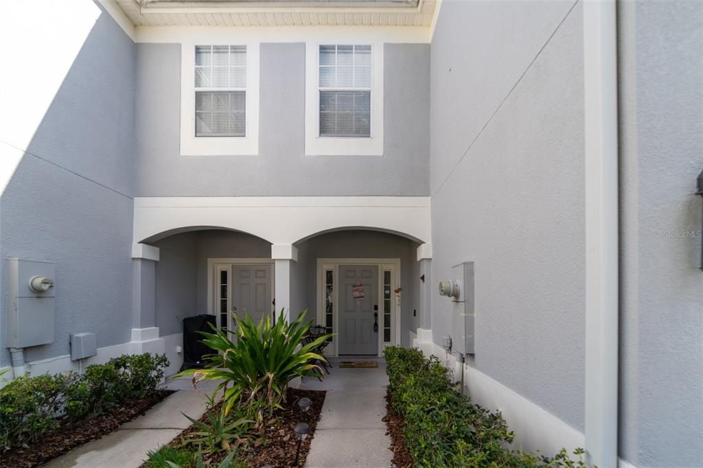 1041 Enclair Street Orlando, FL 32828 - Photo 1 of 62 a front view of a house with garden