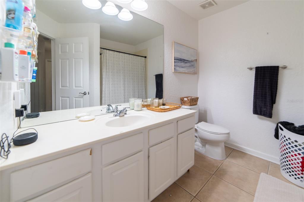 1041 Enclair Street Orlando, FL 32828 - Photo 12 of 62 a bathroom with a toilet sink and mirror