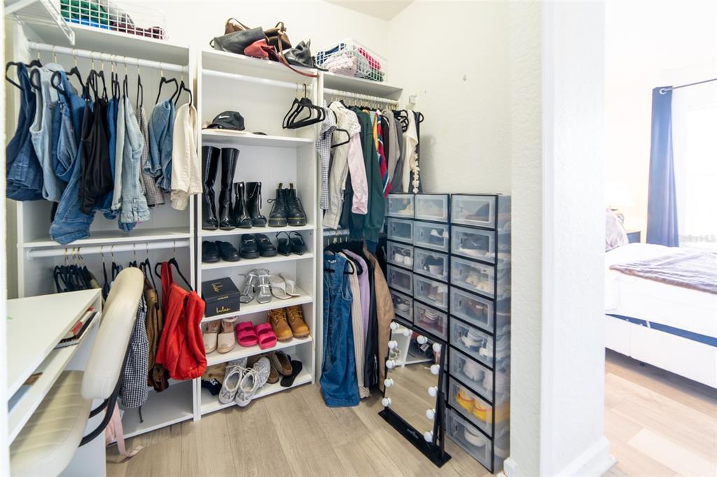 1041 Enclair Street Orlando, FL 32828 - Photo 16 of 62 a view of walk in closet with clothes and shoes