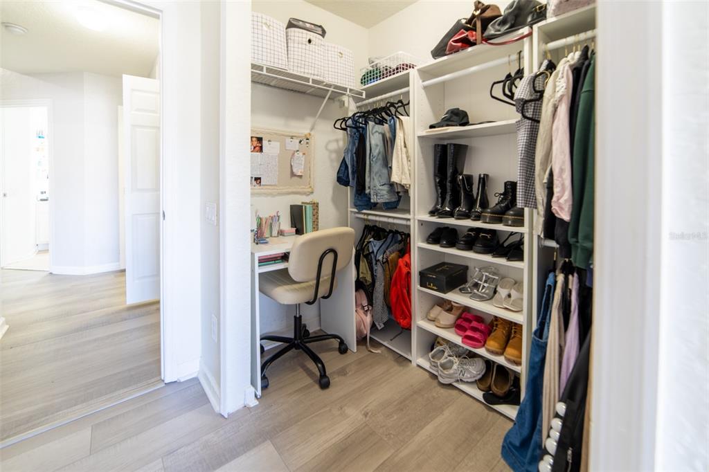 1041 Enclair Street Orlando, FL 32828 - Photo 17 of 62 a view of walk in closet with clothes and shoes