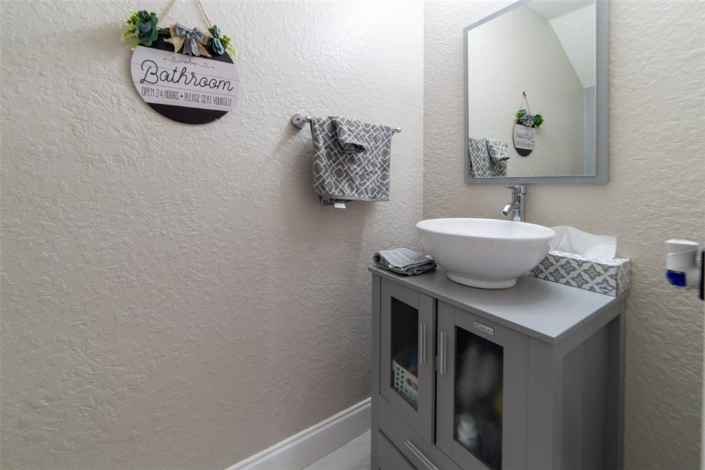 1041 Enclair Street Orlando, FL 32828 - Photo 20 of 62 a bathroom with a sink and a mirror