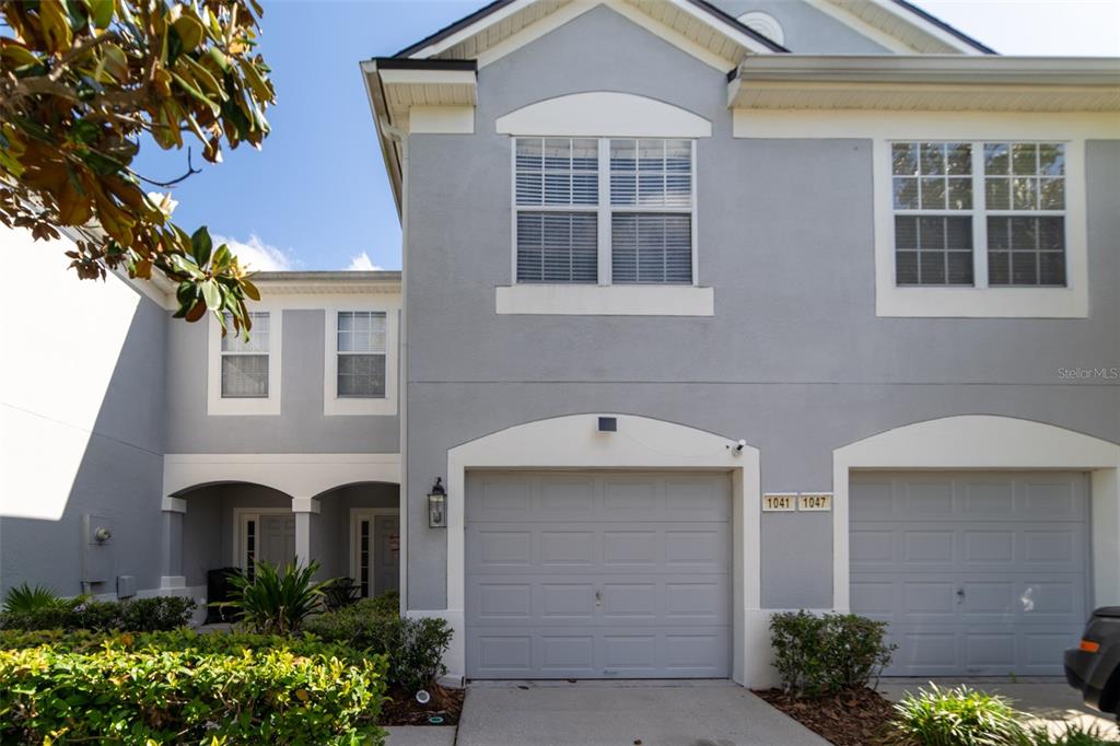 1041 Enclair Street Orlando, FL 32828 - Photo 2 of 62 a front view of a house with a yard