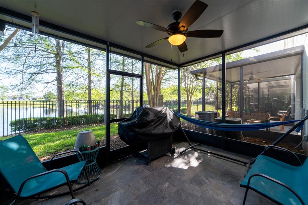 1041 Enclair Street Orlando, FL 32828 - Photo 23 of 62 a living room with furniture and a floor to ceiling window