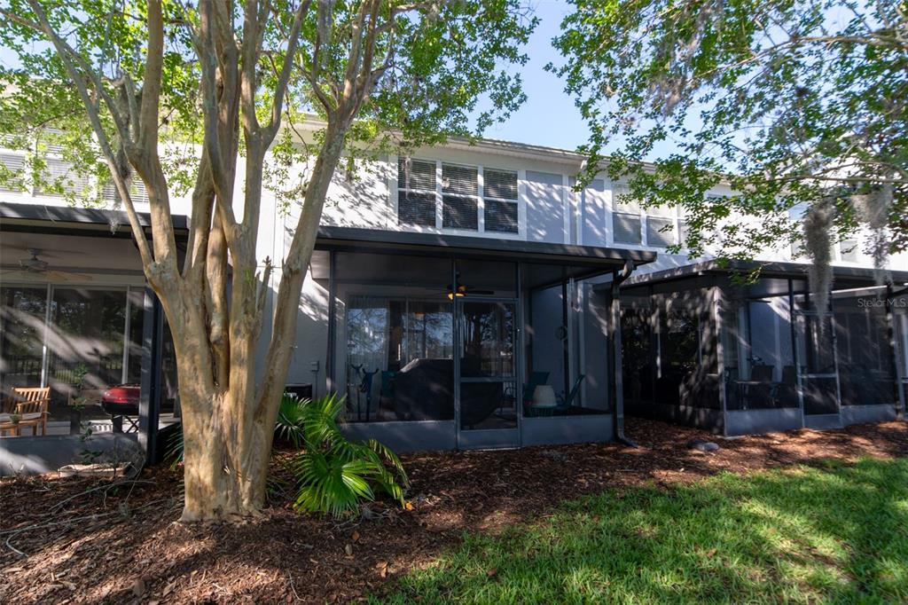 1041 Enclair Street Orlando, FL 32828 - Photo 27 of 62 a view of a house with backyard and trees