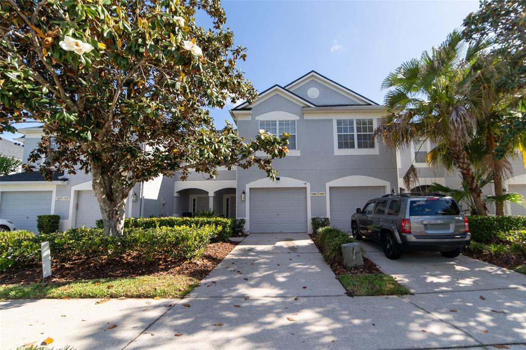 1041 Enclair Street Orlando, FL 32828 - Photo 3 of 62 a front view of a house with a yard and potted plants