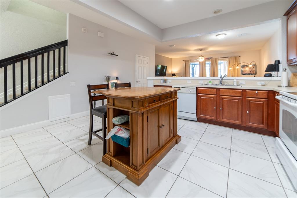 1041 Enclair Street Orlando, FL 32828 - Photo 32 of 62 a kitchen with stainless steel appliances granite countertop a stove a sink and a refrigerator
