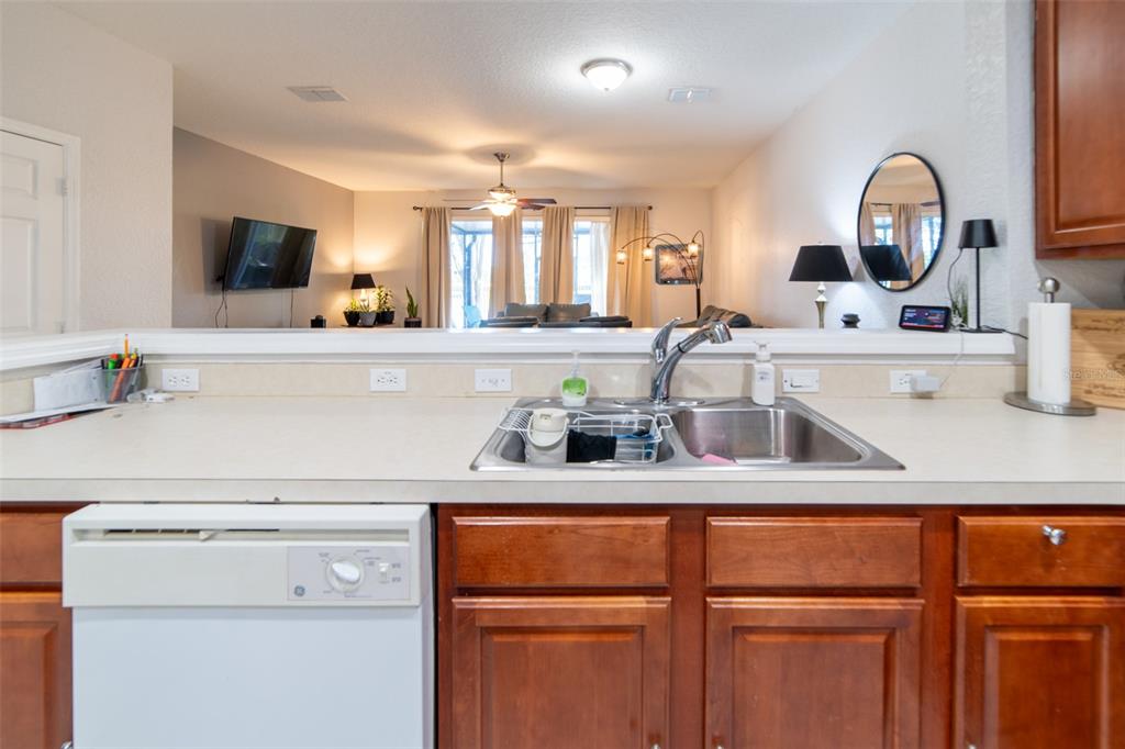 1041 Enclair Street Orlando, FL 32828 - Photo 34 of 62 a kitchen with a sink and a stove top oven