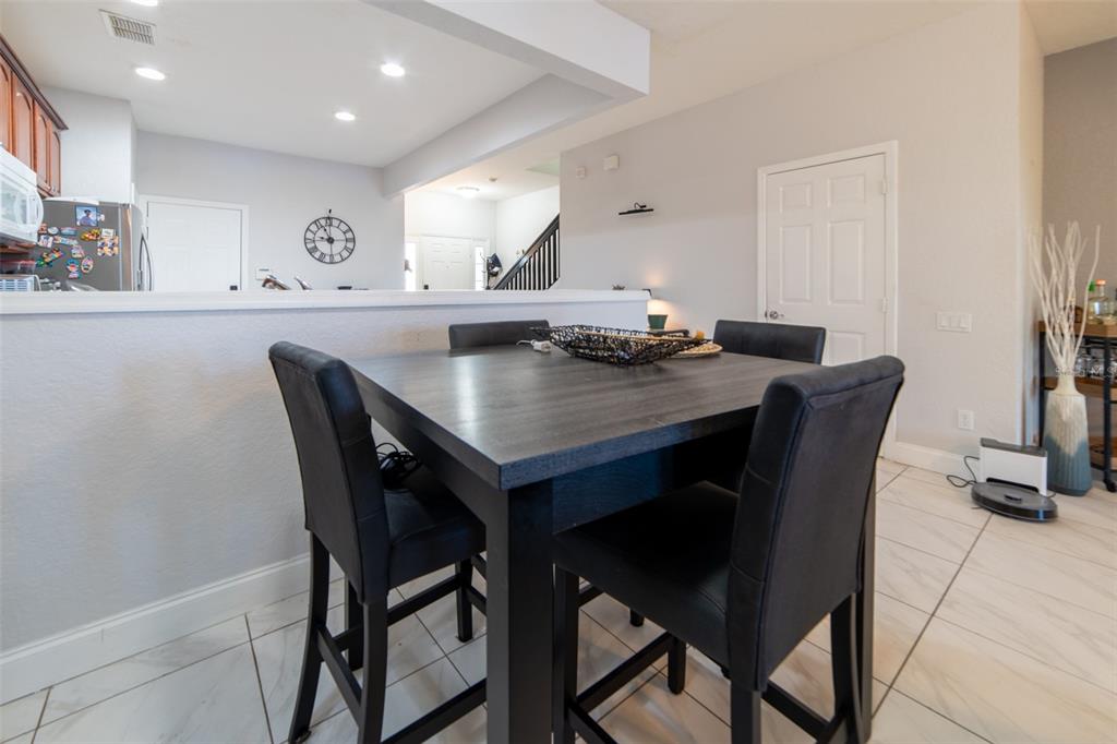 1041 Enclair Street Orlando, FL 32828 - Photo 38 of 62 a view of a dining room with furniture