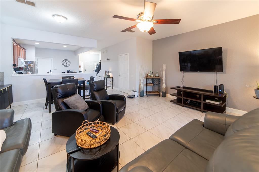 1041 Enclair Street Orlando, FL 32828 - Photo 40 of 62 a living room with furniture and a flat screen tv