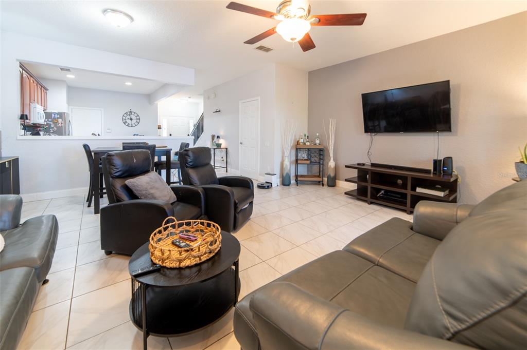 1041 Enclair Street Orlando, FL 32828 - Photo 41 of 62 a living room with furniture and a flat screen tv