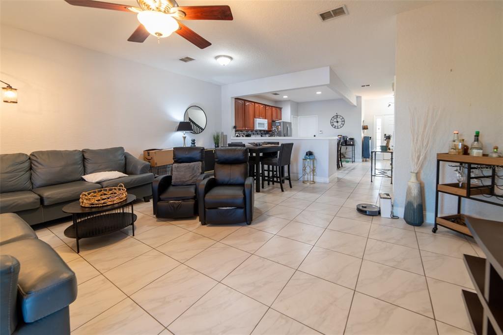 1041 Enclair Street Orlando, FL 32828 - Photo 42 of 62 a living room with furniture and a flat screen tv