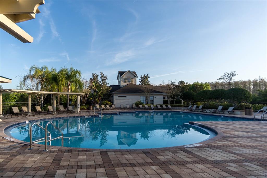 1041 Enclair Street Orlando, FL 32828 - Photo 54 of 62 a view of a swimming pool with outdoor seating