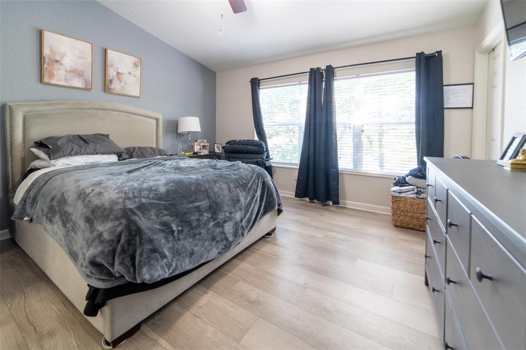1041 Enclair Street Orlando, FL 32828 - Photo 8 of 62 a spacious bedroom with a bed and a window
