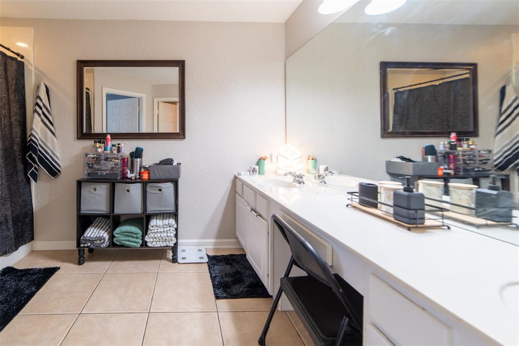 1041 Enclair Street Orlando, FL 32828 - Photo 10 of 62 a bathroom with a sink and a mirror