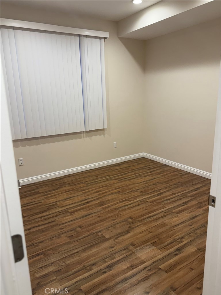 9951 Marcus Avenue, Unit 104 Tujunga, CA 91042 - Photo 16 of 16 a view of room with wooden floor