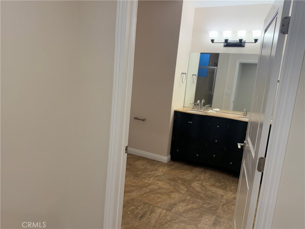 9951 Marcus Avenue, Unit 104 Tujunga, CA 91042 - Photo 7 of 16 a bathroom with a sink and a mirror