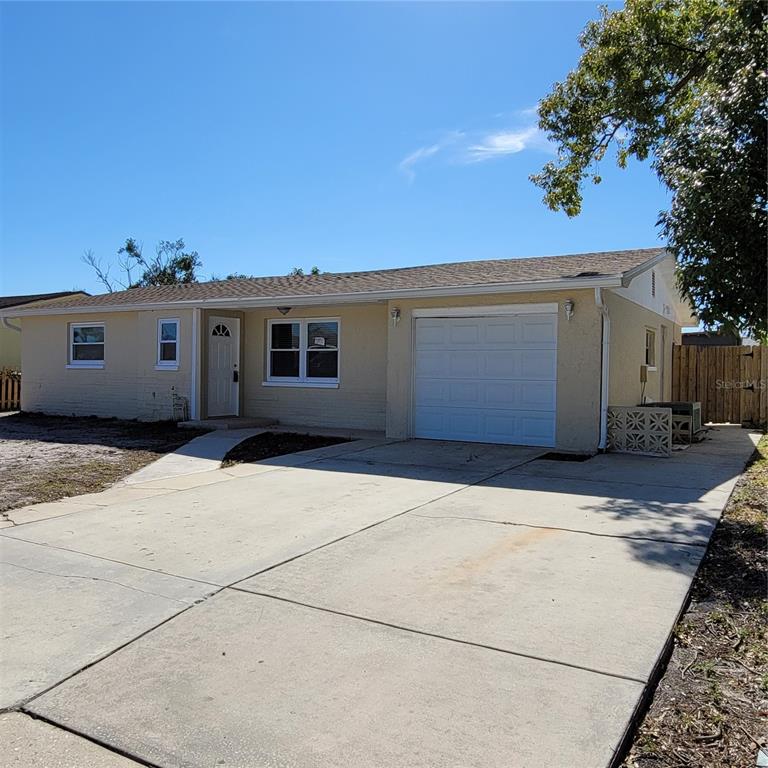 7410 Ivanhoe Drive Port Richey, FL 34668 - Photo 1 of 1 a view of garage with a yard