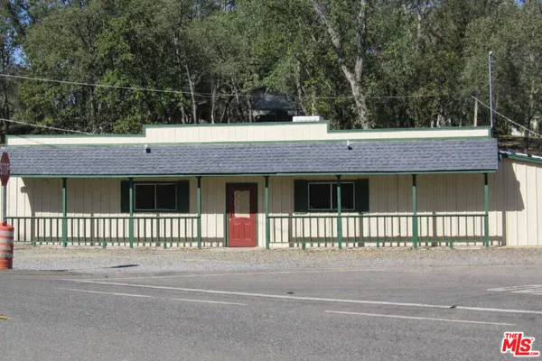 a view of a house with a wooden fence