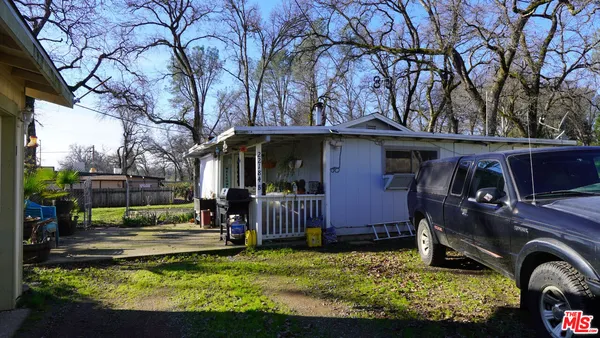 a view of a house with backyard fireplace and furniture