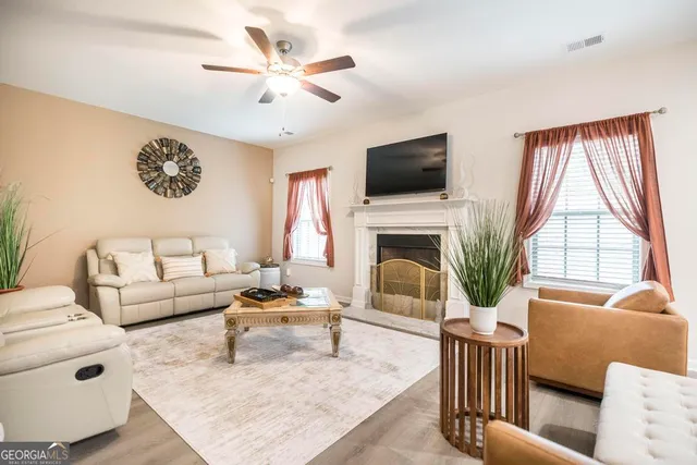 a living room with furniture fireplace and a flat screen tv