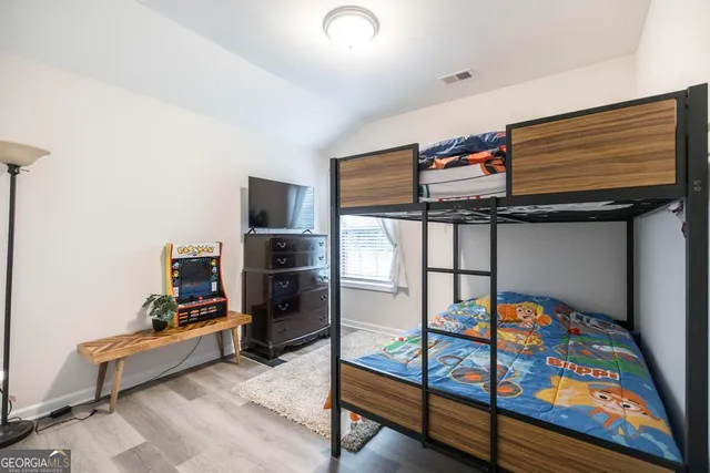 a bedroom with furniture and a window