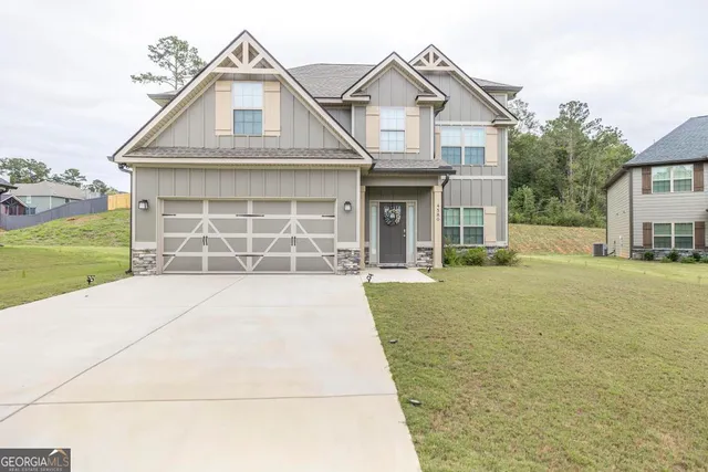 a front view of a house with a yard and garage