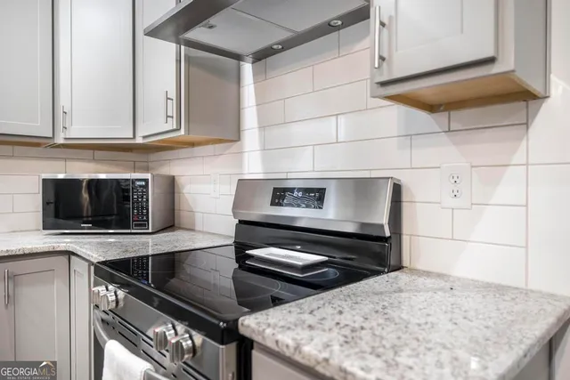 a kitchen with a stove and a microwave