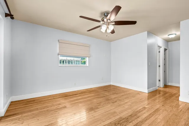 a view of a big room with wooden floor and windows in a room