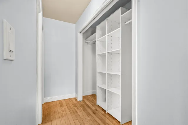 a view of closet area with empty racks