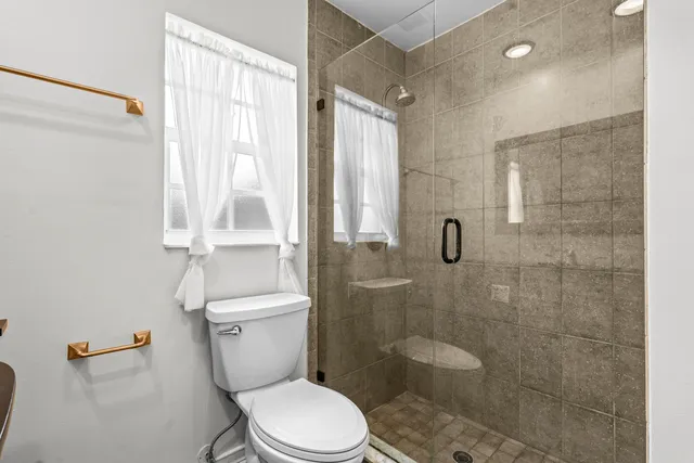 a white toilet sitting next to a bathroom sink