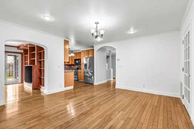 a view of a kitchen with wooden floor and a ceiling fan