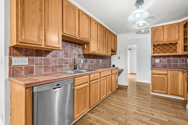 a kitchen with stainless steel appliances granite countertop a sink stove and cabinets
