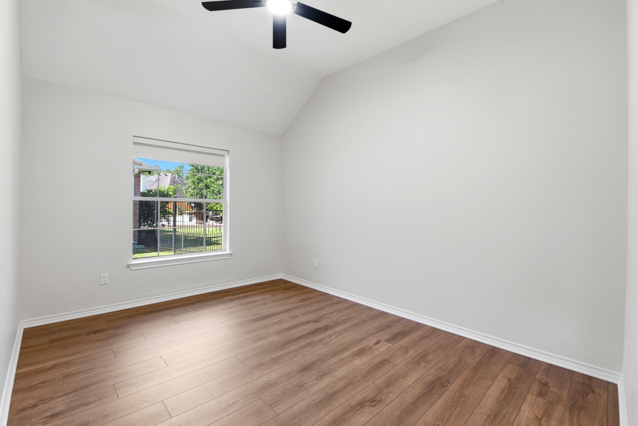29819 South Legends Village Circle Spring, TX 77386 - Photo 35 of 48 an empty room with wooden floor chandelier fan and windows