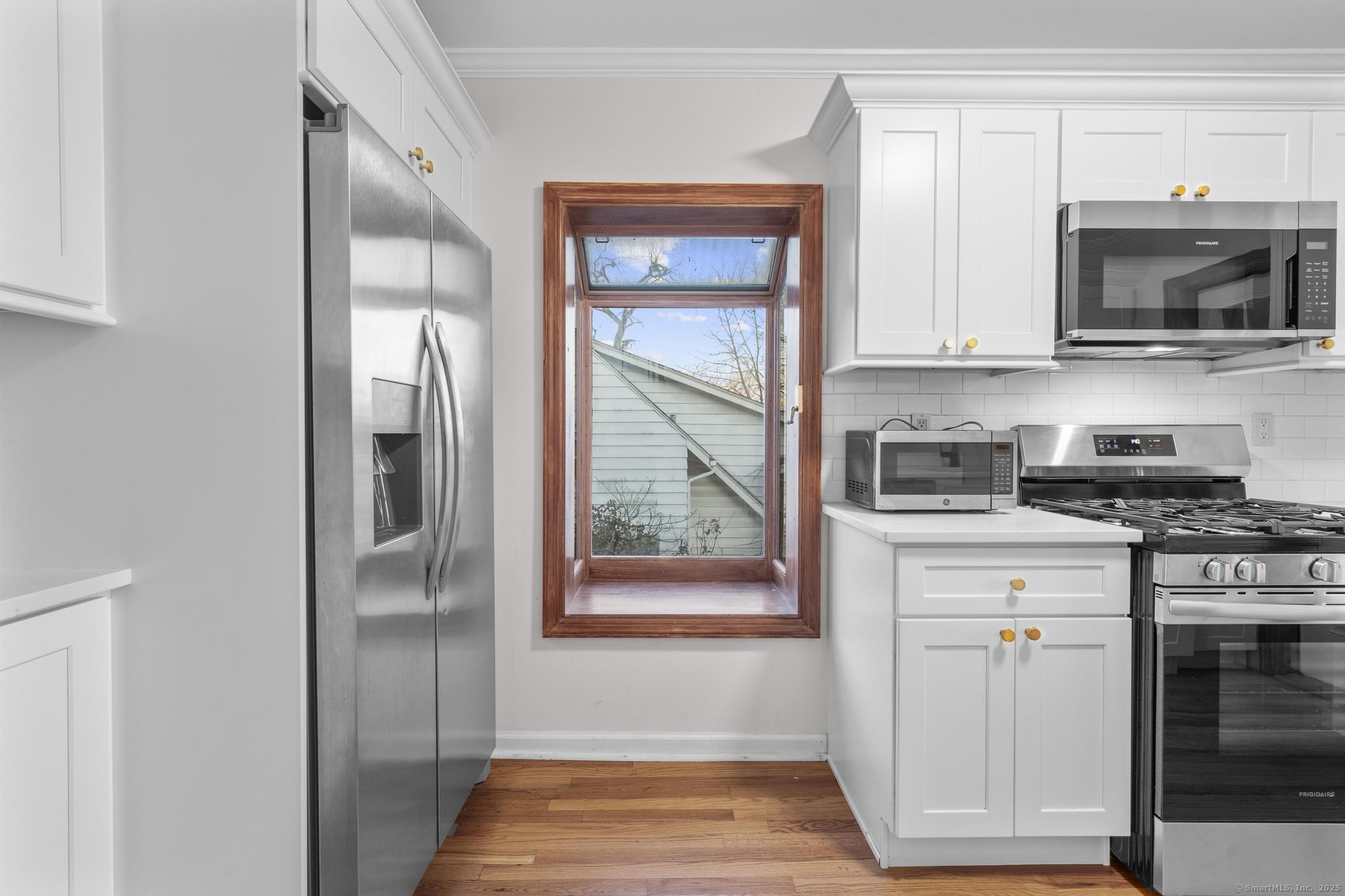 33 Douglas Avenue, Unit 2 Stamford, CT 06906 - Photo 11 of 32 a kitchen with stainless steel appliances granite countertop a refrigerator and a stove top oven