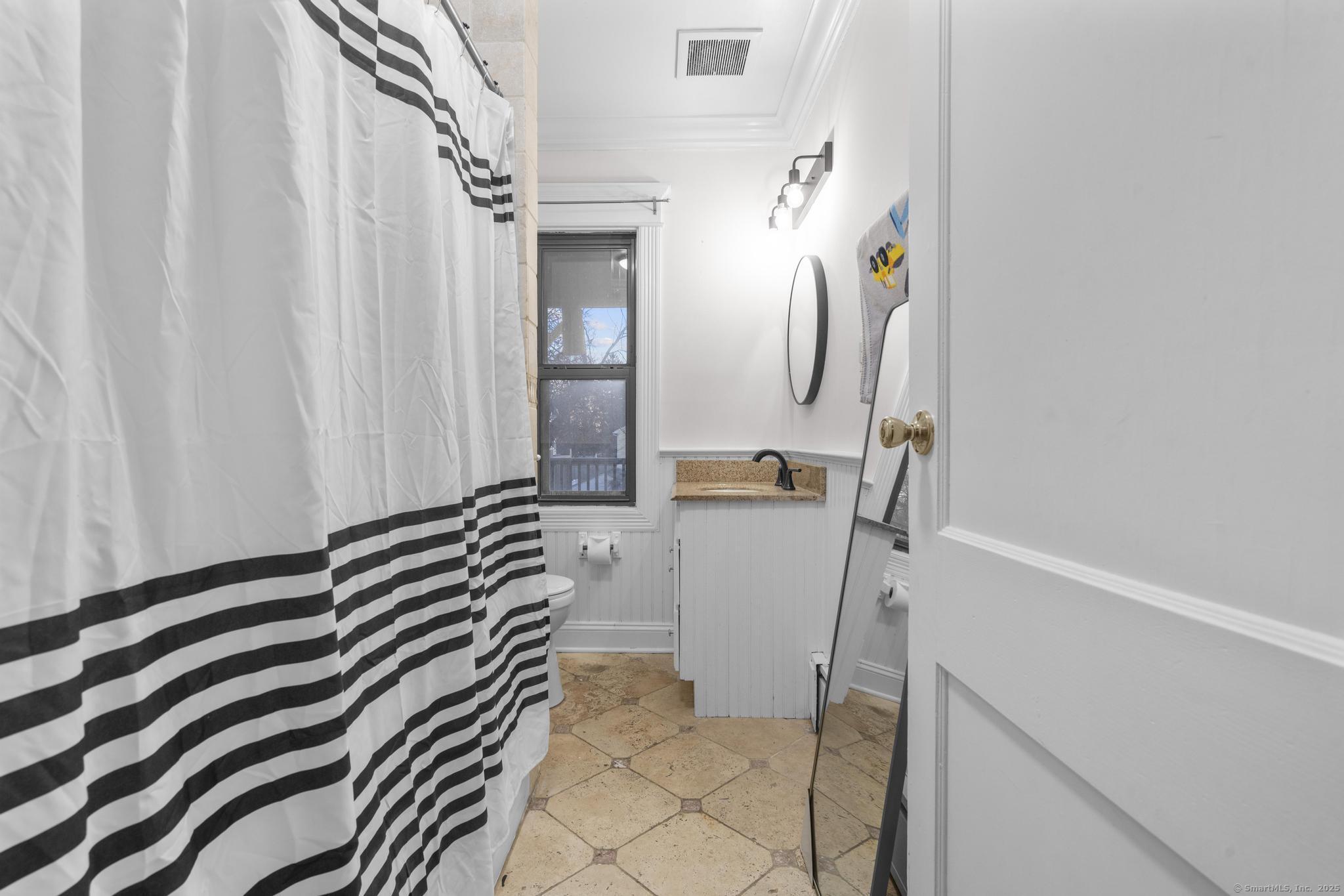 33 Douglas Avenue, Unit 2 Stamford, CT 06906 - Photo 13 of 32 a bedroom with a bed and a cabinets