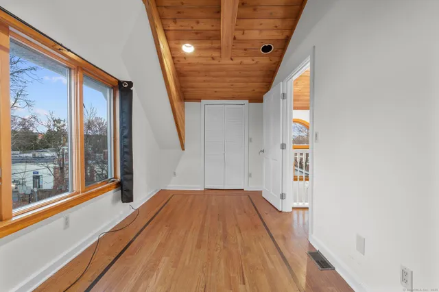 a view of a room with wooden floor and iron stairs