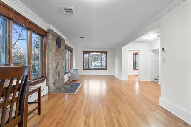 a view of an entryway with wooden floor and door