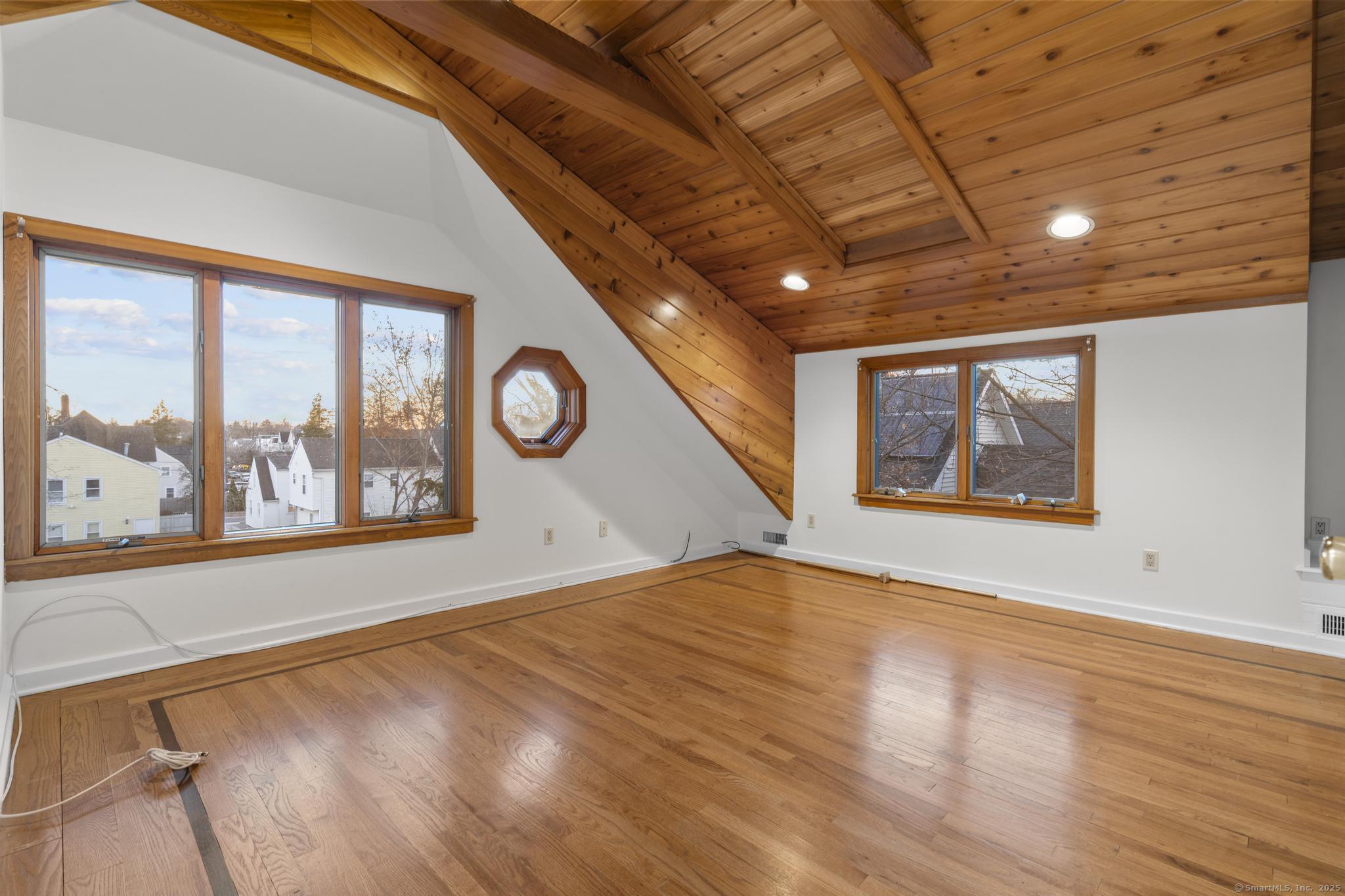 33 Douglas Avenue, Unit 2 Stamford, CT 06906 - Photo 23 of 32 a view of an empty room with a window and wooden floor