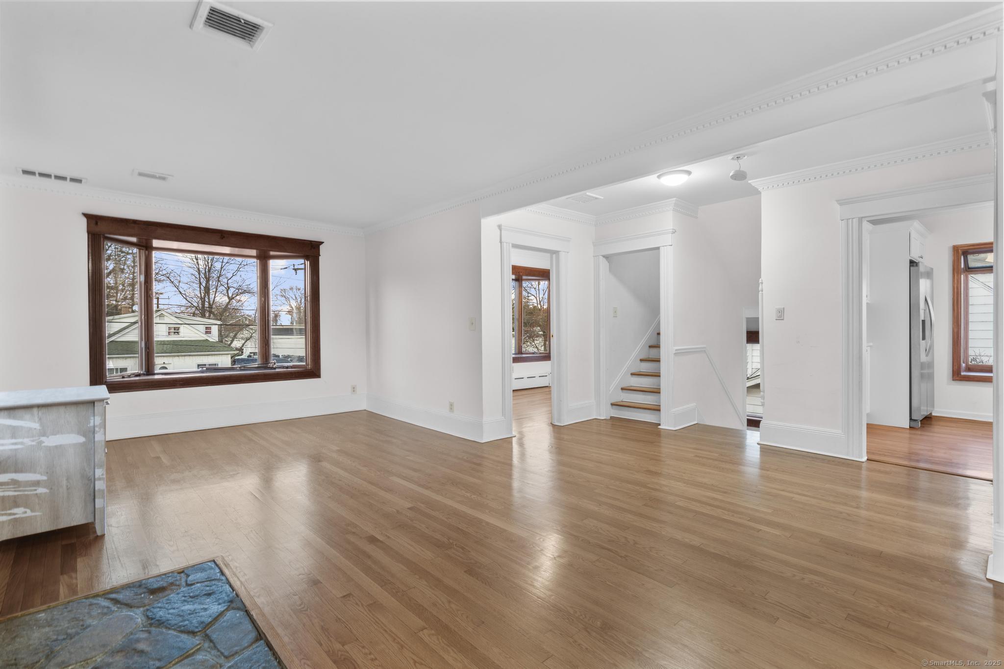 33 Douglas Avenue, Unit 2 Stamford, CT 06906 - Photo 3 of 32 an empty room with wooden floor and windows