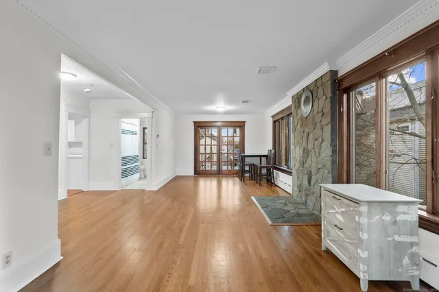 a view of a living room hardwood floor and a window