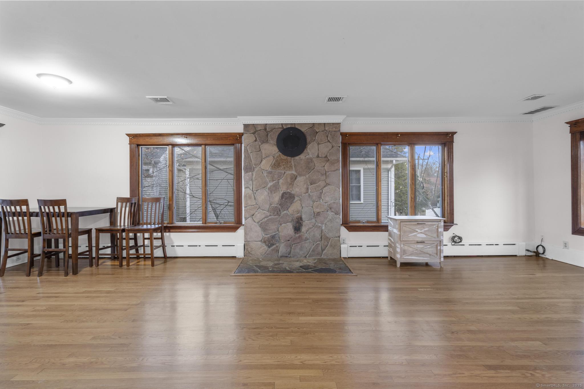 33 Douglas Avenue, Unit 2 Stamford, CT 06906 - Photo 6 of 32 a view of empty room with wooden floor and fireplace