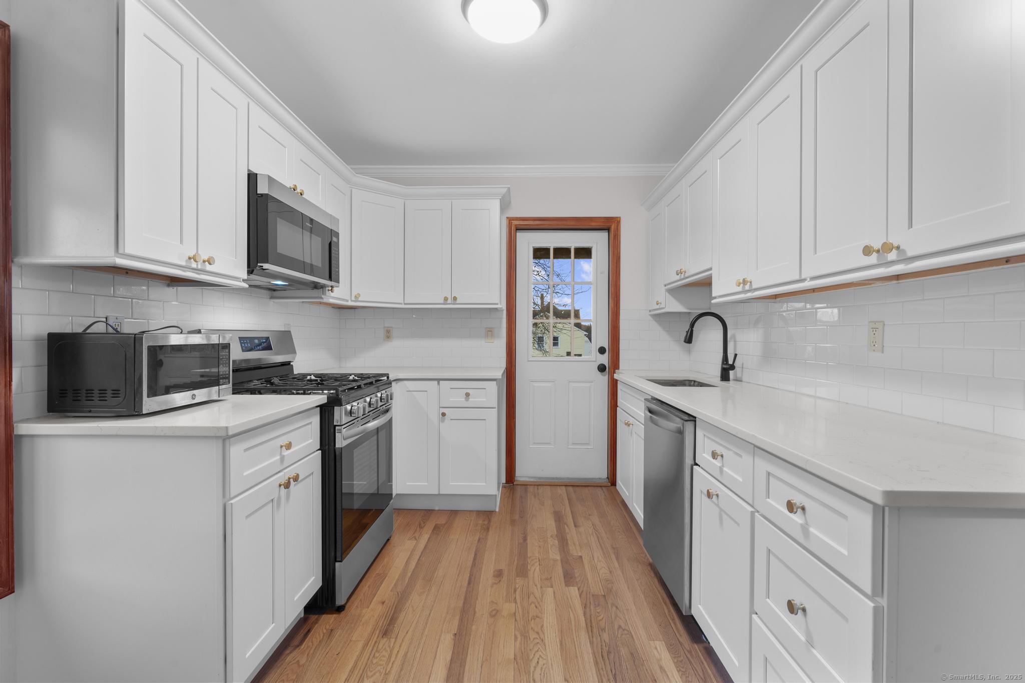33 Douglas Avenue, Unit 2 Stamford, CT 06906 - Photo 8 of 32 a kitchen with stainless steel appliances granite countertop a sink and a stove top oven