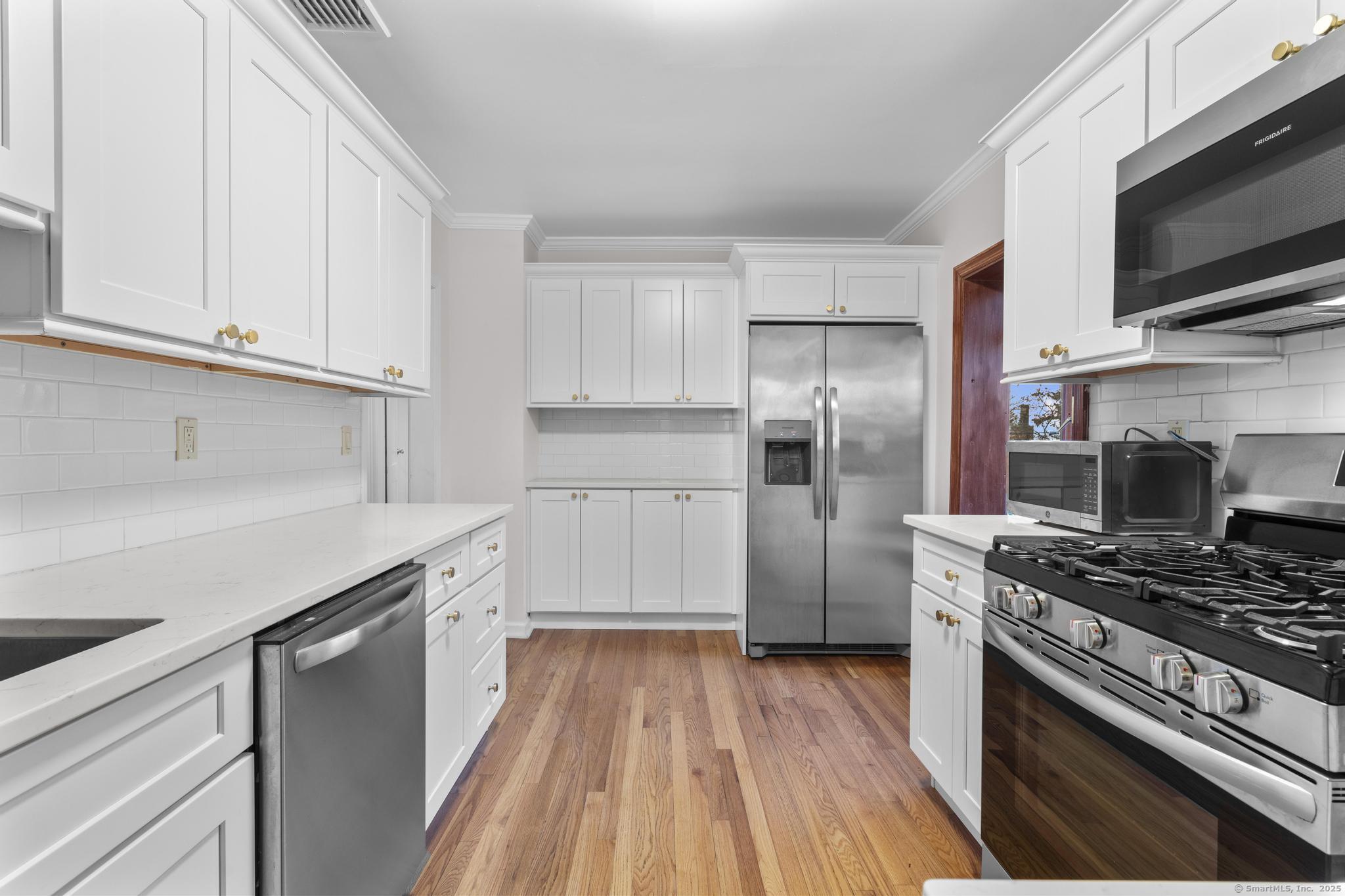 33 Douglas Avenue, Unit 2 Stamford, CT 06906 - Photo 9 of 32 a kitchen with stainless steel appliances a refrigerator stove and microwave