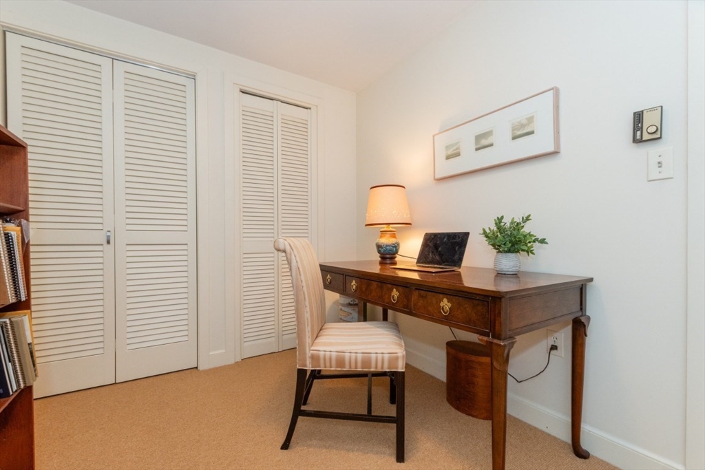 73 Valentine Street Newton, MA 02465 - Photo 12 of 26 a view of a workspace with furniture and wooden floor