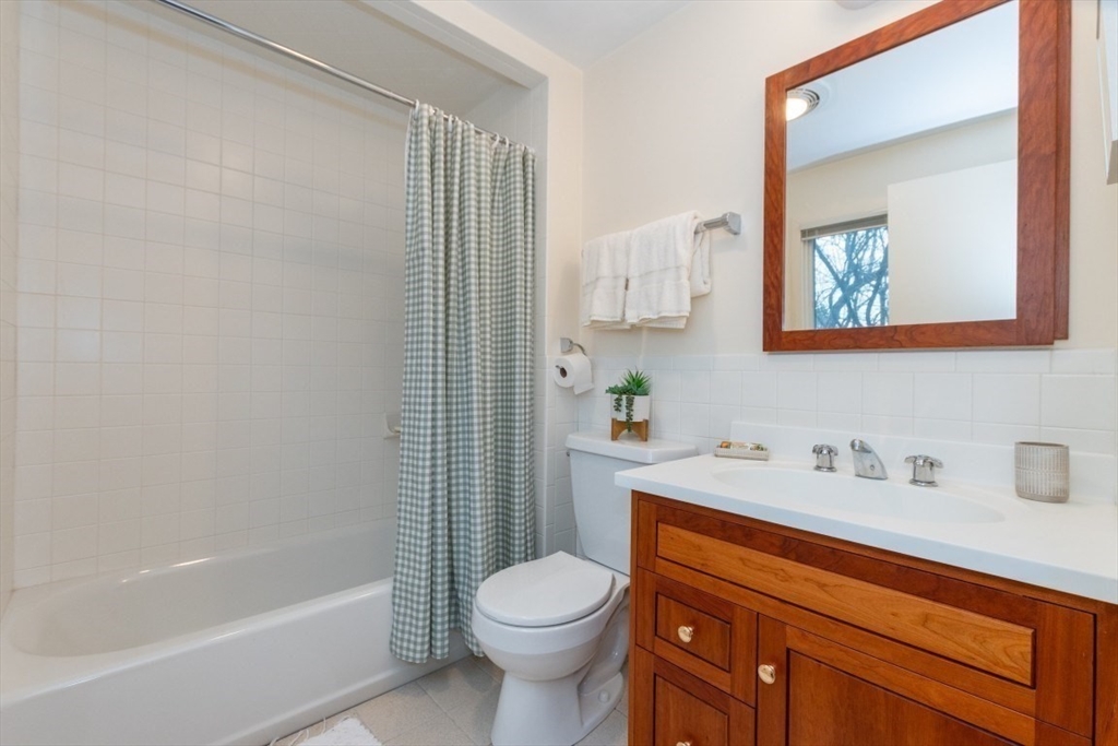 73 Valentine Street Newton, MA 02465 - Photo 18 of 26 a bathroom with a sink toilet and shower
