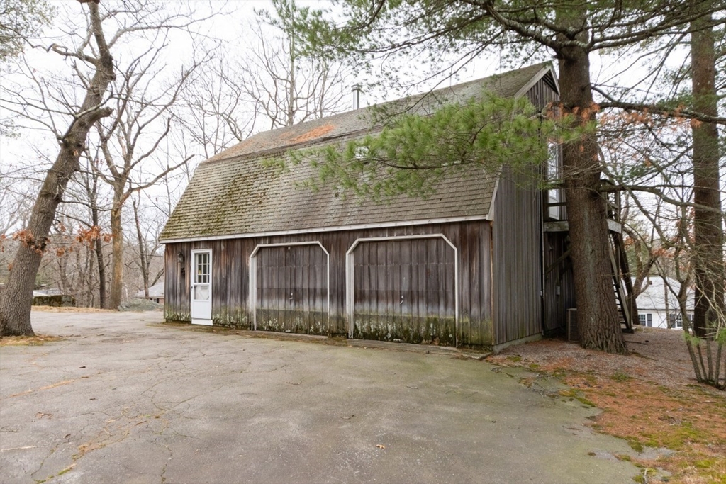 73 Valentine Street Newton, MA 02465 - Photo 19 of 26 a front view of a house with a yard and garage