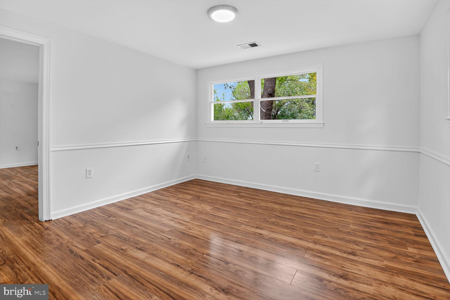202 East Gordon Street Sterling, VA 20164 - Photo 15 of 20 a view of an empty room with wooden floor and a window