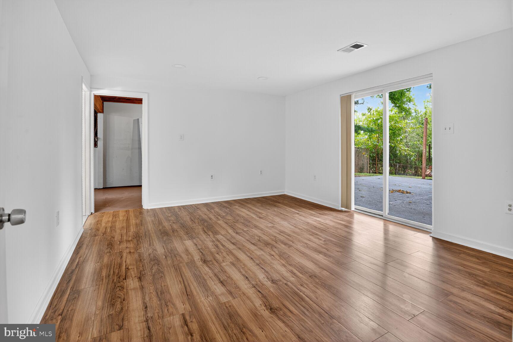202 East Gordon Street Sterling, VA 20164 - Photo 16 of 20 a view of an empty room with wooden floor and a window