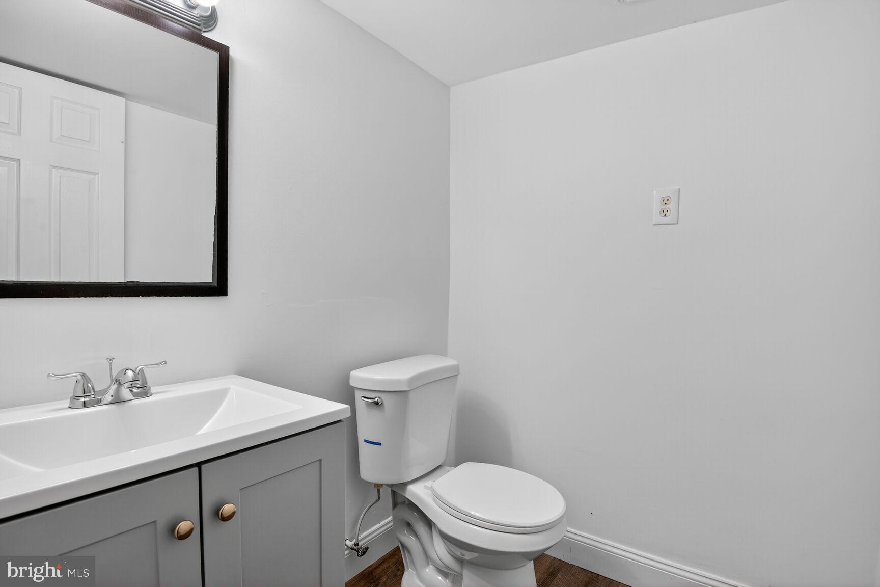 202 East Gordon Street Sterling, VA 20164 - Photo 18 of 20 a bathroom with a sink a toilet and mirror