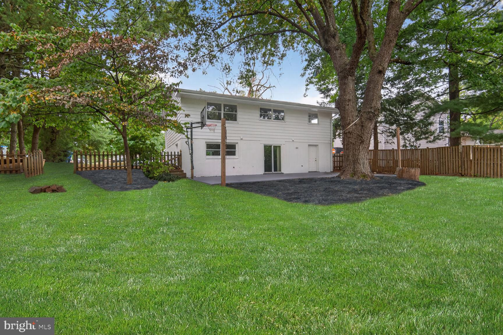 202 East Gordon Street Sterling, VA 20164 - Photo 20 of 20 a view of a white house with a small yard and a large tree